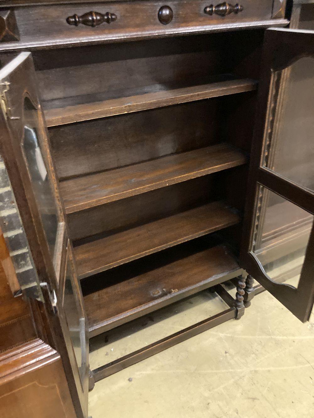 A 1920s oak two door glazed bookcase, width 92cm depth 30cm height 140cm